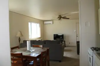 Tres Casitas dining room to living room with carpet